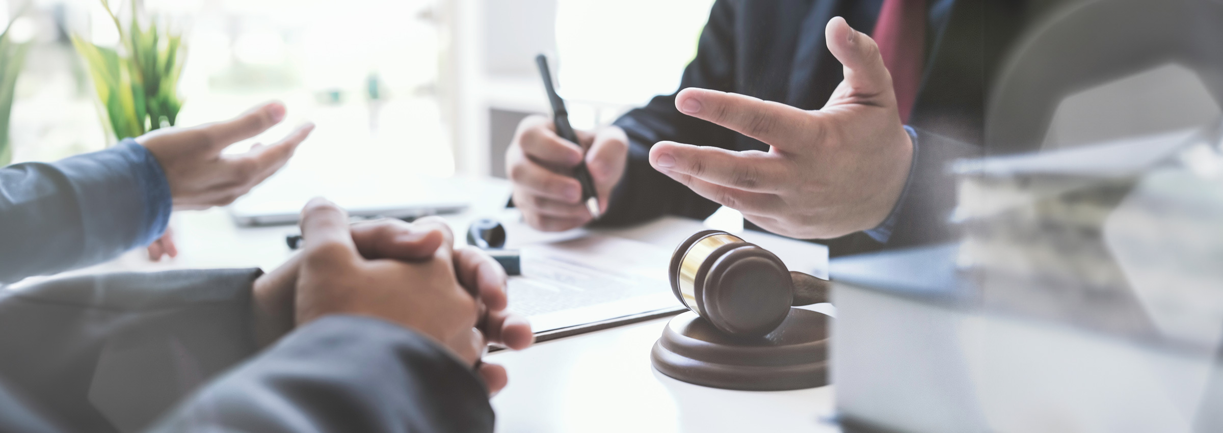 View of people's hands only while sitting at a desk with a gavel