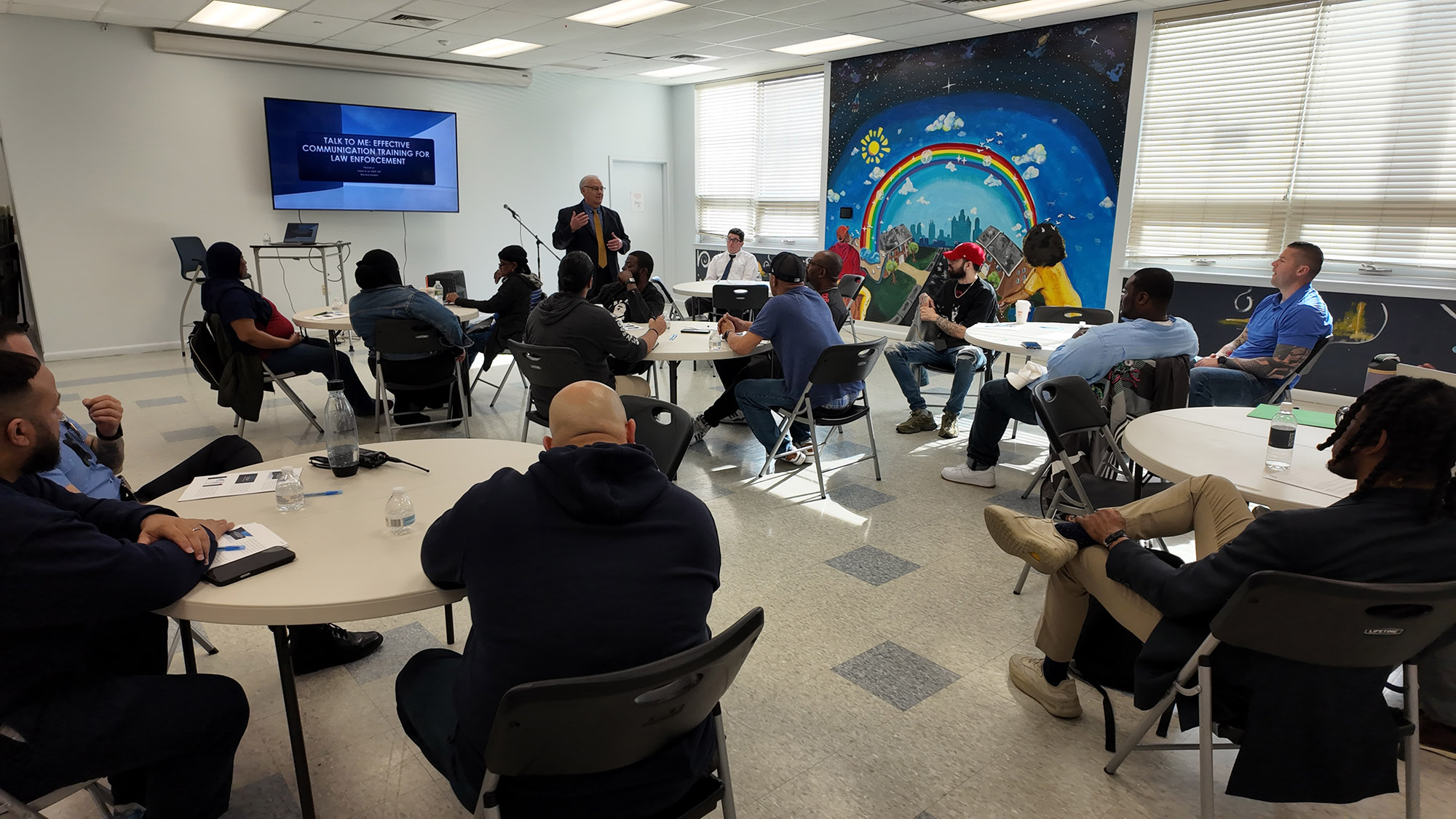 A group of officers and community members participates in de-escalation training in Philadelphia, PA.